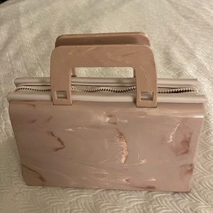 This Melissa handbag still looks like new. It has never been used. Fresh smell.